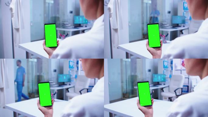 内科医生看着绿屏手机