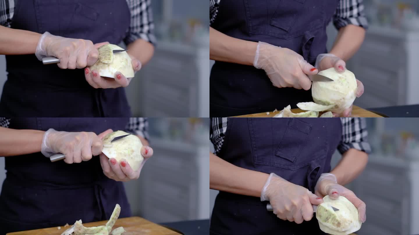 戴着手套的女性用菜刀从白色的芜菁甘蓝中准备一道菜
