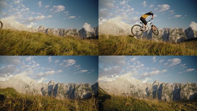 在阳光明媚的日子里，山地自行车手在草地上用自行车表演特技