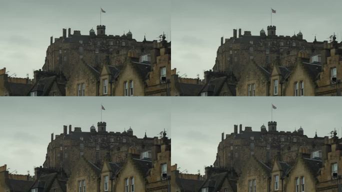 阴天，著名的爱丁堡城堡矗立在古老的石头联排别墅的屋顶上