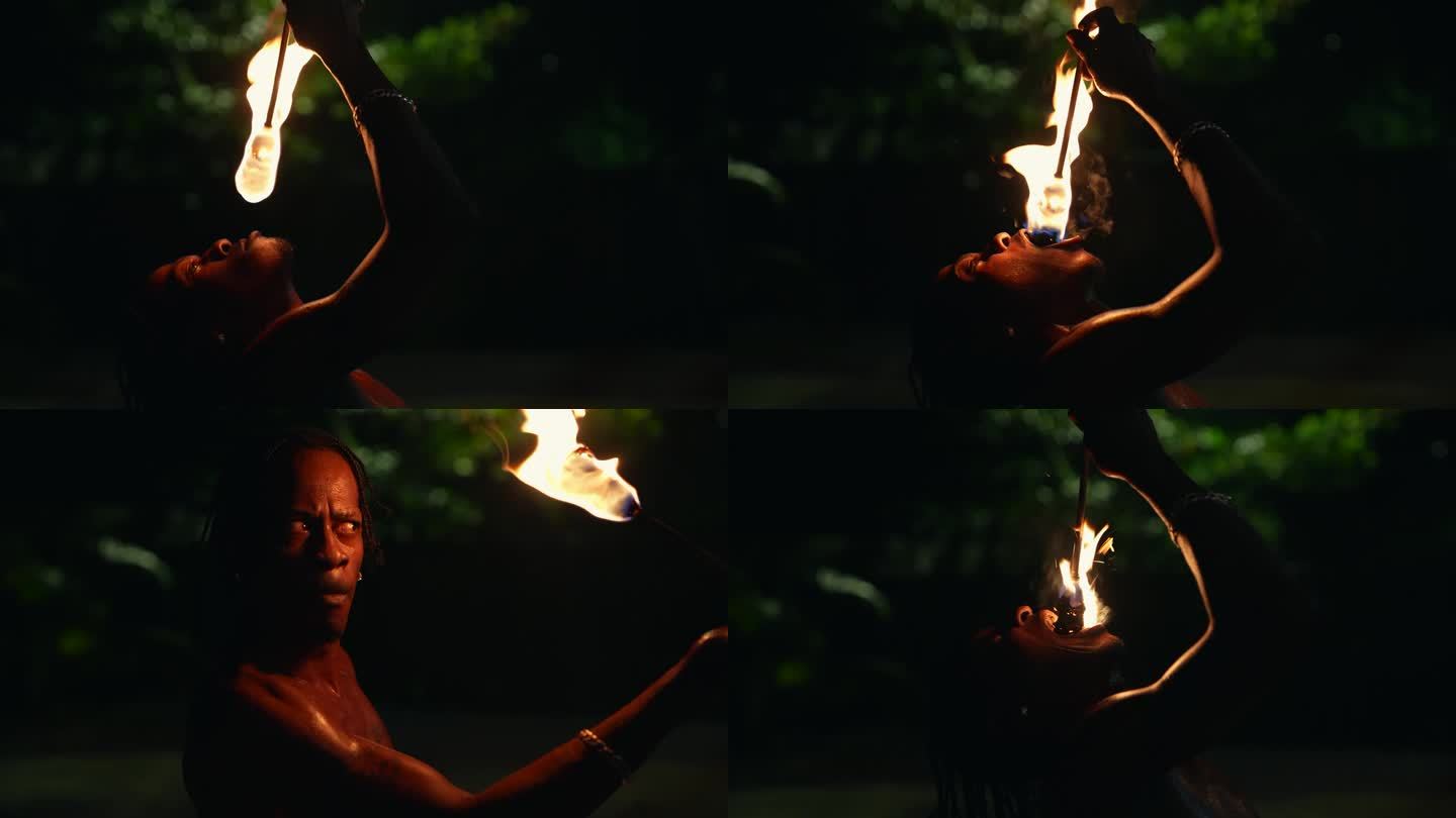 牙买加黑人表演者正在进行火表演、火表演、喷火、火舞、玩火、吃火。蒙特哥湾，牙买加