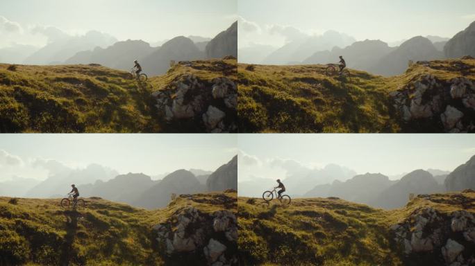 在阳光明媚的日子里，坚定的男子骑自行车在草山上对着天空的慢动作锁定镜头