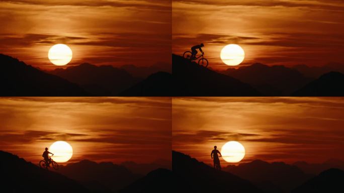 SLO MO锁定镜头的剪影运动员骑自行车下坡对戏剧性的天空在日落