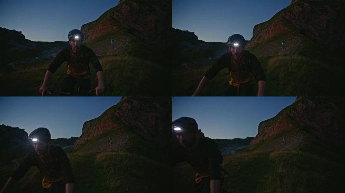 SLO MO决定骑自行车的人戴着发光的头灯在草地上骑自行车，在暮色中湛蓝的天空