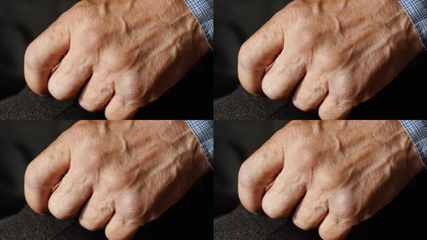 老人把手放在脚上。老龄化和老年观念。一位老人手臂上的静脉。