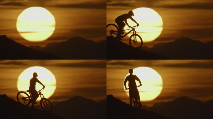 SLO MO锁定拍摄的剪影骑自行车下降和站在山上对雄伟的太阳在日落