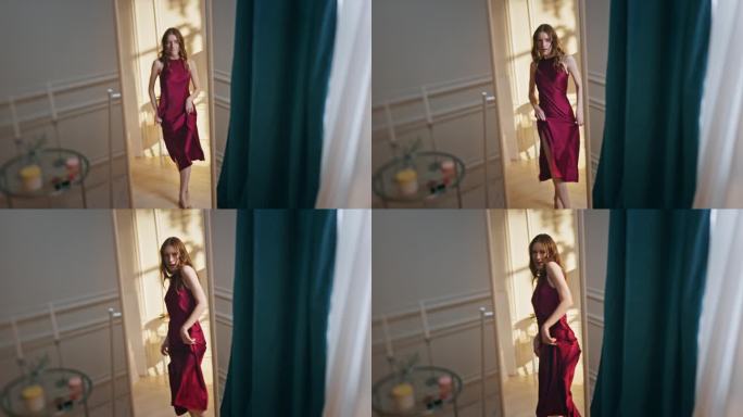 无忧无虑的女孩穿着浪漫的红裙子在镜子里跳舞。快乐微笑模型
