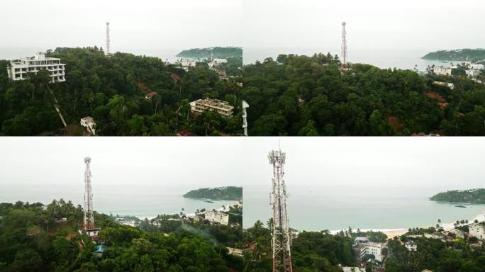 鸟瞰图显示了海边茂密的热带森林中高耸的蜂窝桅杆。技术基础设施使电信，广播服务在偏远的岛屿。沿海景观显