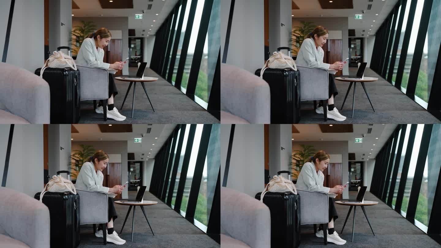 亚洲女商人在机场候机大厅用笔记本电脑进行视频通话虚拟会议。实时在线沟通和业务咨询预约