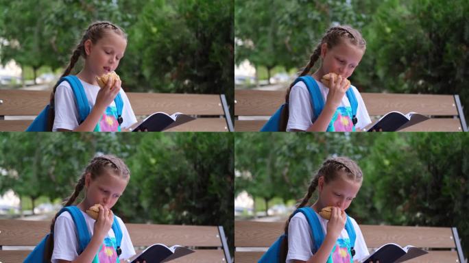 一个女学生坐在长凳上重复她的功课。公园里一个背着运动包的孩子一边吃苹果一边学习。