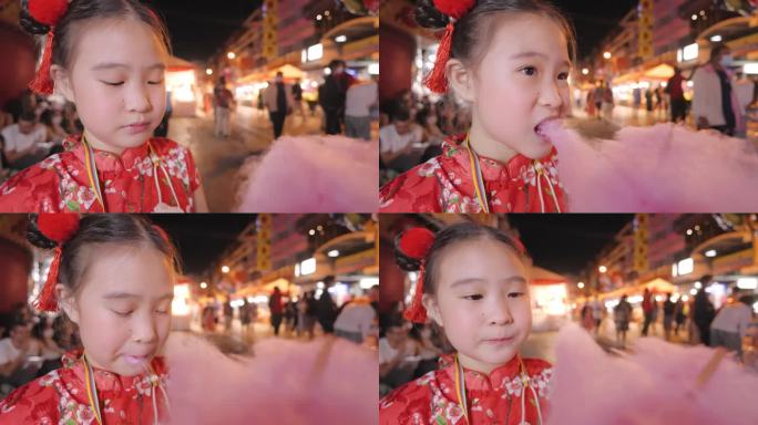 大年初一，穿着旗袍的女孩在街市上吃棉花糖