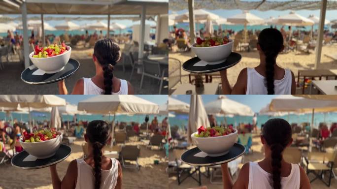 沙滩咖啡馆里，不知名的女服务员端着托盘和水果盘