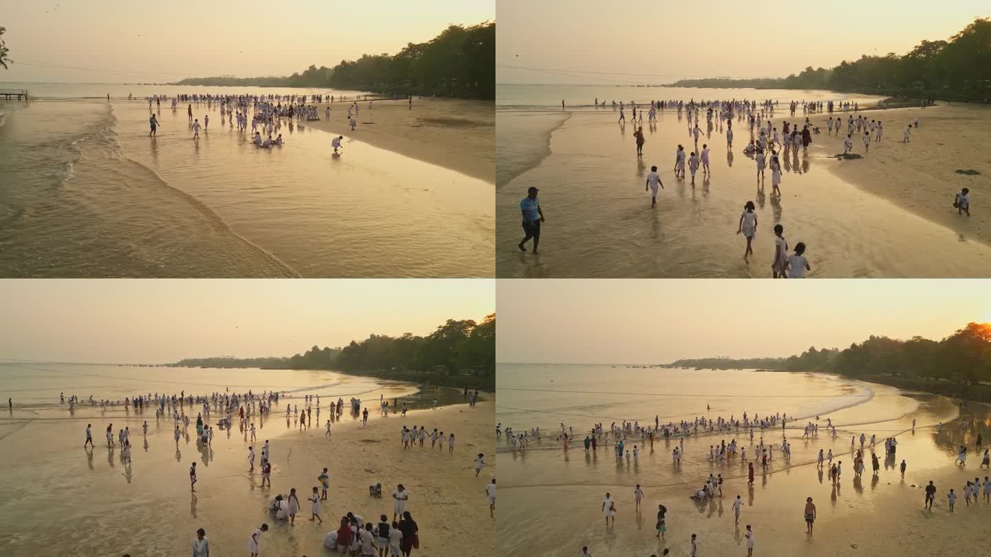 孩子们穿着白色制服在沙滩上欢快地玩耍，海浪拍打着夕阳。群享海边活动体现了无忧无虑的青春，纯真在海边自