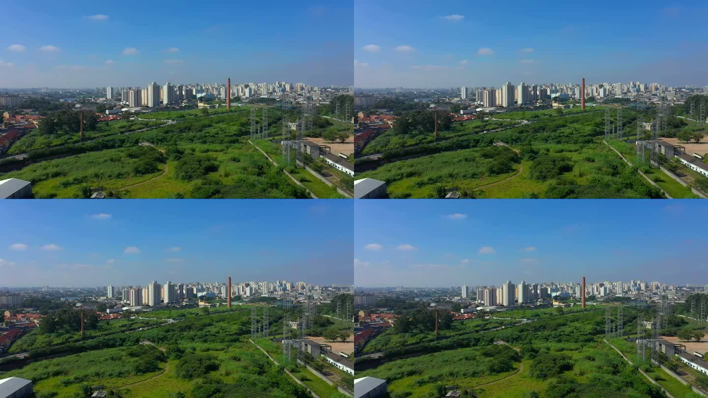 在晴朗的蓝天下，无人机拍摄的现代城市景观