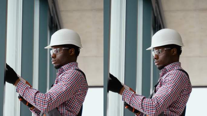 非洲窗户安装工人在安装pvc窗户时使用硅胶泡沫。垂直视频