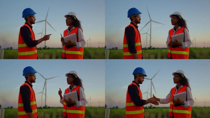 男性技术人员向女性工程师报告风力发电机的发电问题，并接受工程师的故障排除步骤，然后握手。