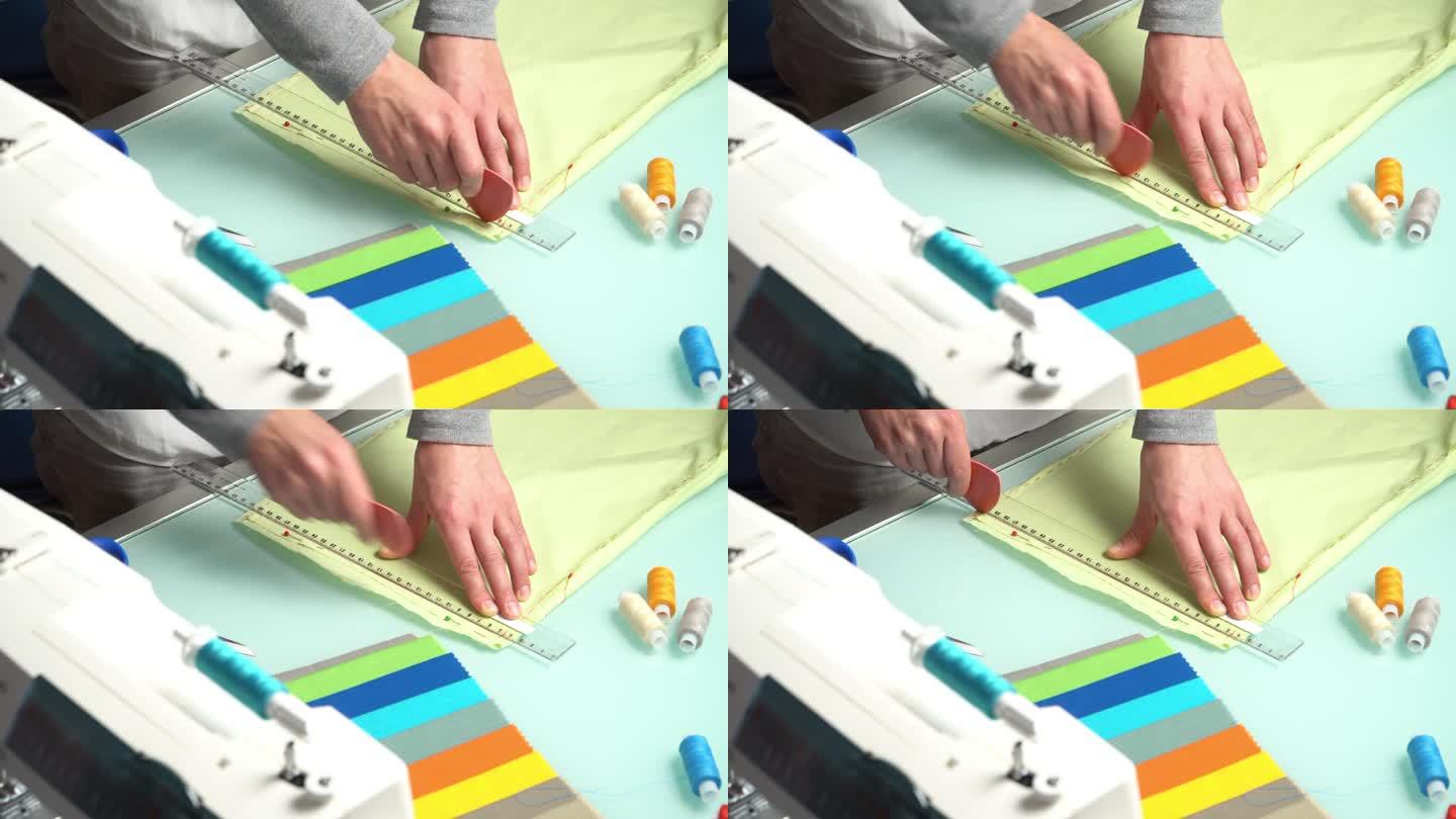 裁缝用粉笔在薄荷织物上做记号。实时视频。