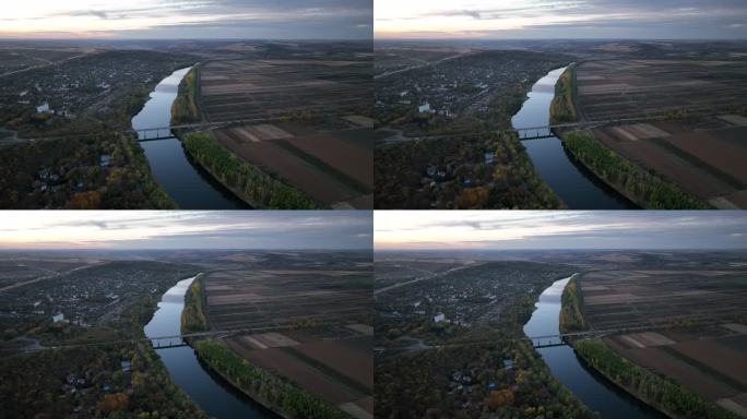 晚上的飞机飞过与德涅斯特河大桥平行的河流