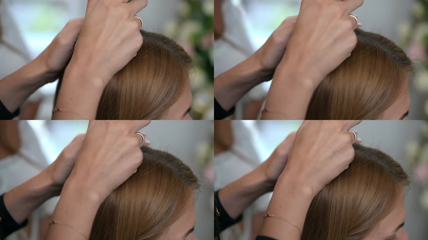 在美发沙龙里，一位女毛发学家双手拿着trichoscopy在一个女孩的头上。特写镜头。