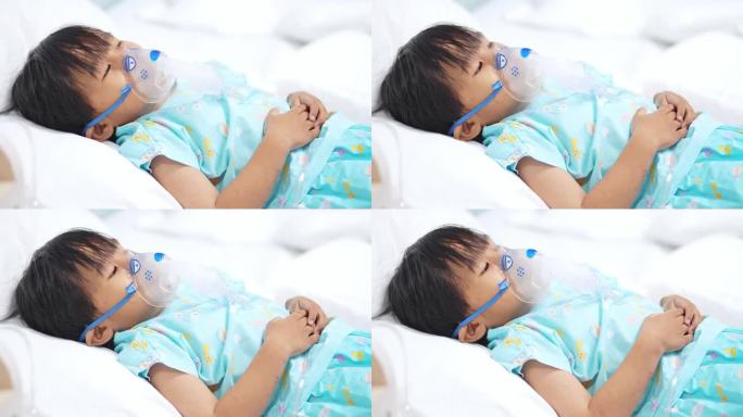 亚洲男孩躺在床上用吸入器治疗肺病。
