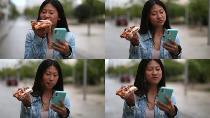 亚洲女人边吃披萨边走边看智能手机
