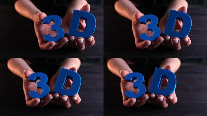 女孩展示用3D打印机打印的三维字母