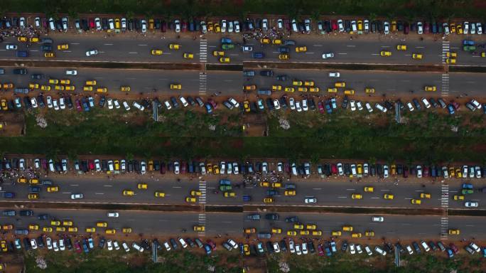 在喀麦隆雅温得市，无人机在交通和停放的汽车上空拍摄
