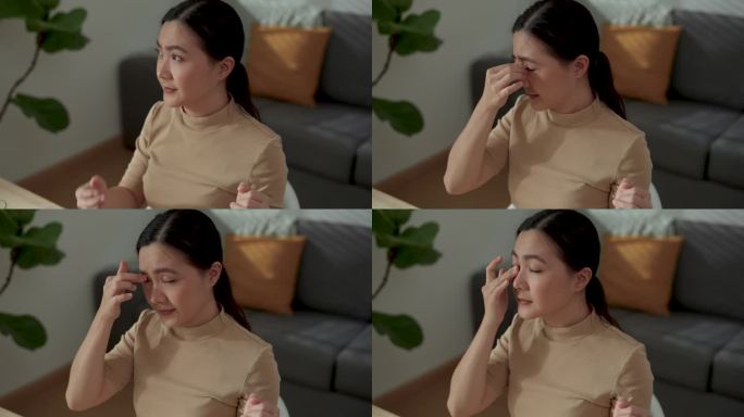 亚洲女性在家办公时眼睛酸痛。