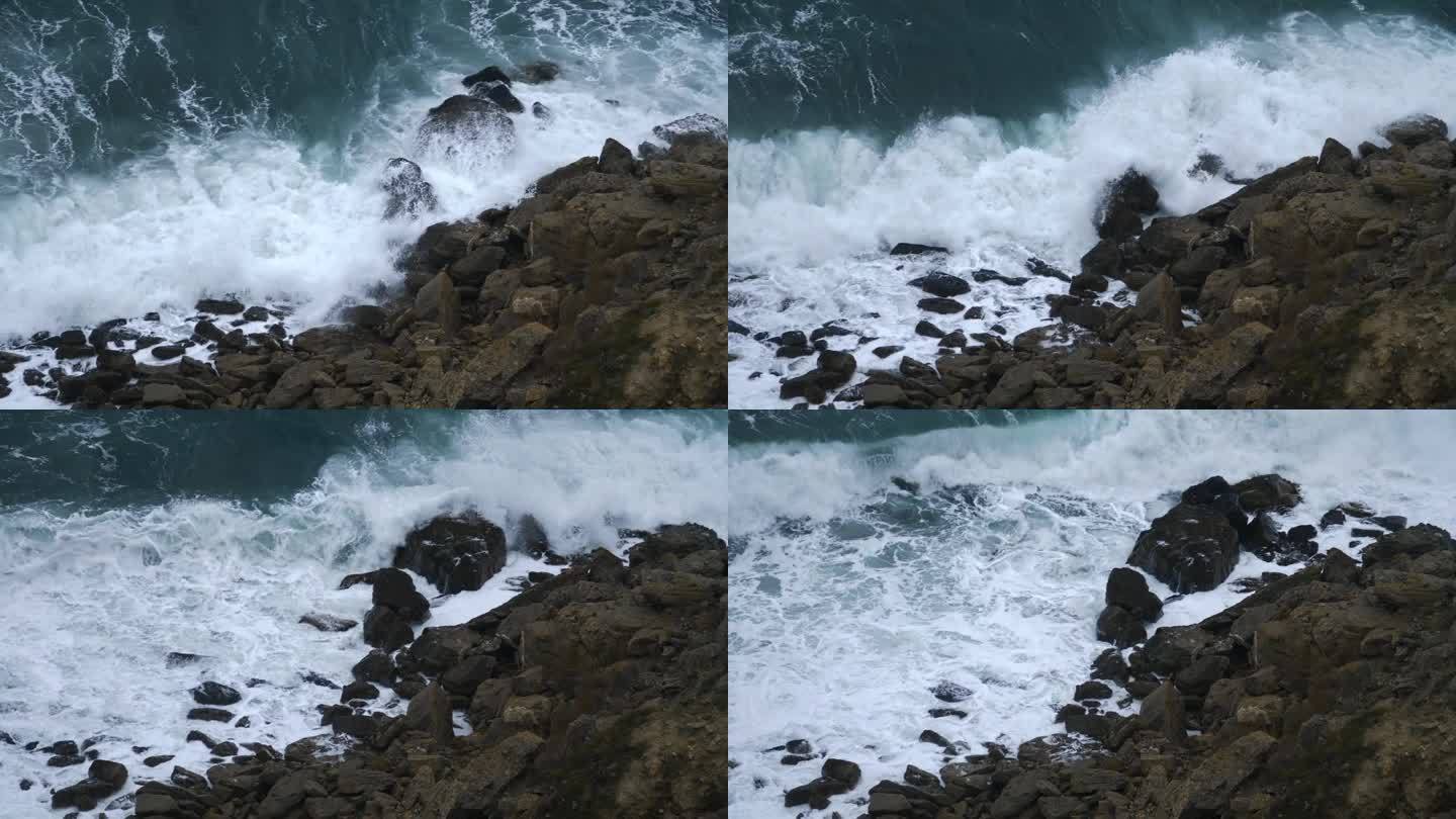 慢动作俯视图。碧绿的海浪带着白色的泡沫拍打着岩石海岸。阴暗而美丽的海景。积极情绪的涌动