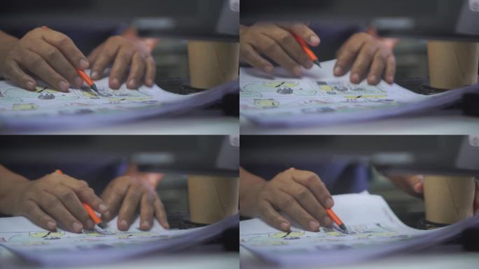 视频前期制作电影分镜概念:手绘分镜动画漫画纸箱，在工作室设计创意场景布局。制作影片拍摄前的幕后工作，