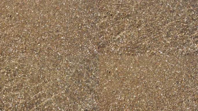 沙质海床穿过清澈的海水。