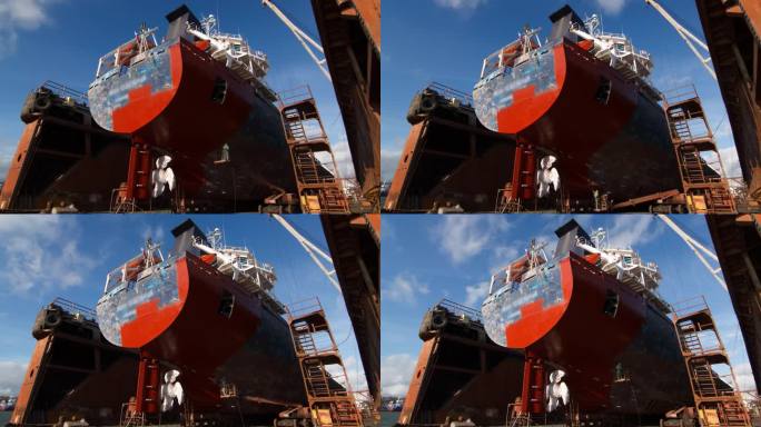 船舶翻新码头，工人们在快速涂漆。鸟瞰图船体修复涂层。工业船舶重漆，干船坞大修。海事维修，船坞工人活动