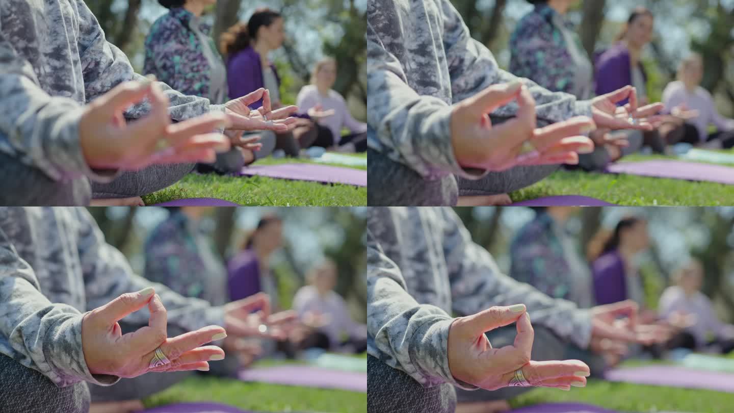 户外瑜伽冥想中手持手印的女性之手