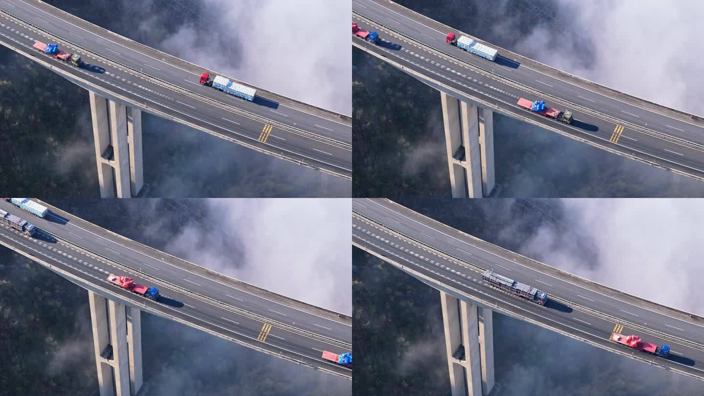 航拍深山大雾高速公路桥梁货车行驶