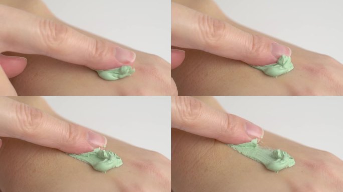 涂抹于手上的泥霜面膜。绿色面霜面膜用于手部皮肤。斯沃琪绿色面霜面膜。