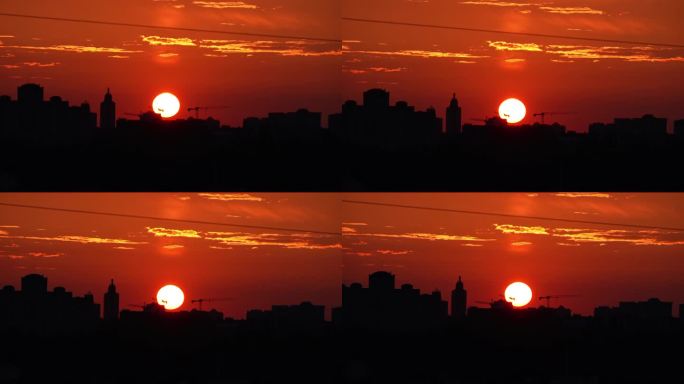 夕阳在大城市的背景下。夕阳与橘红色的天空在城市景观与建筑物的剪影