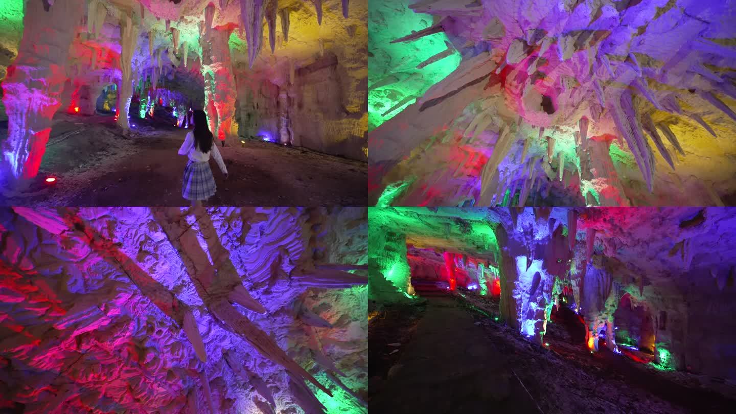 女生在五光十色的山洞里游玩