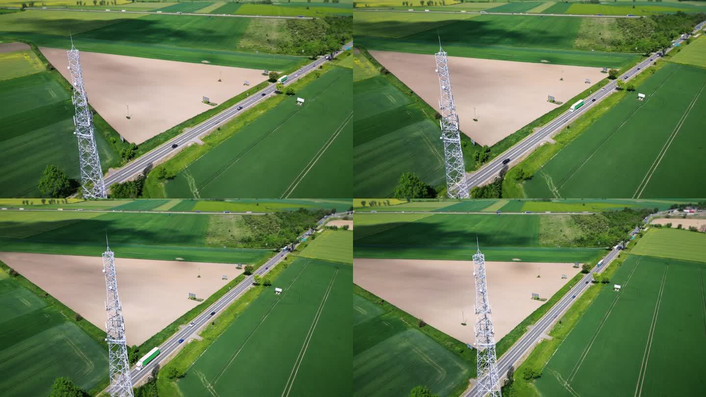 鸟瞰图:位于乡村公路附近的蜂窝天线与过往的车辆。传送数字信号的电信塔。无线通信，数据传输，5G。4 