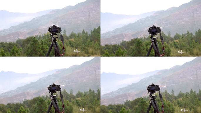 山谷里佳能相机架在三脚架上拍摄风光风景