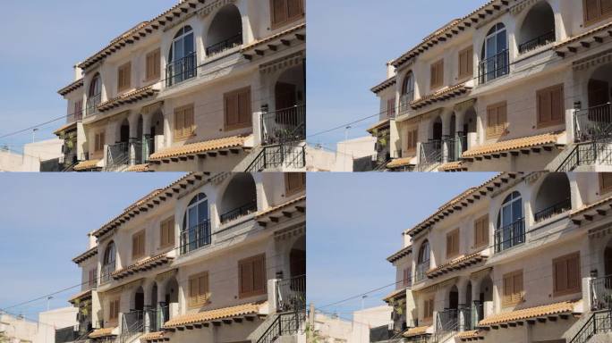镜头从西班牙度假小镇的彩色建筑上移开，房产销售视频。Torrevieja,西班牙。