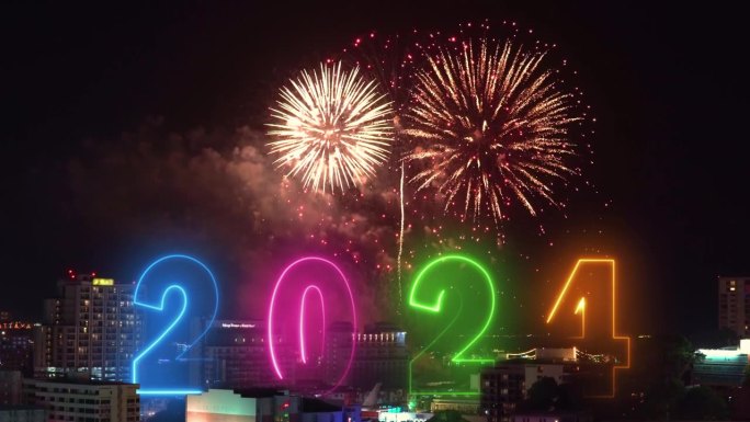 新年快乐2024文字发光的霓虹线字庆祝问候与彩色烟花背景城市景观之夜