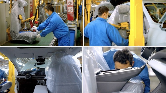 汽车工厂工人安装汽车座椅