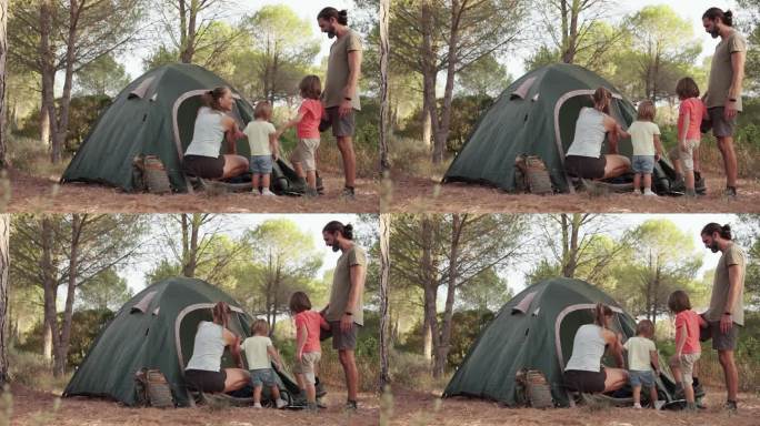 父亲和他的家人充气床垫睡在露营帐篷里