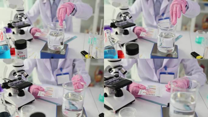 科学家和测试条与不同颜色的指标进行液体分析
