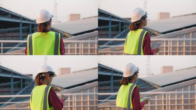 一名戴安全帽的妇女在太阳能发电站检查电力供应