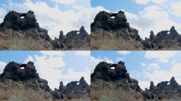 冰岛Dimmuborgir崎岖的熔岩形成的时间流逝，展示了多云天空下大自然的艺术
