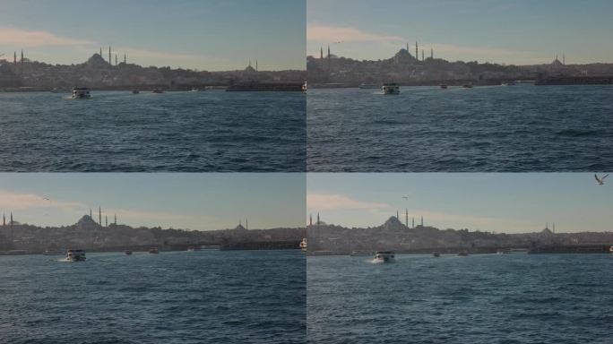 土耳其伊斯坦布尔，海上蓝天下的城市景观中的清真寺