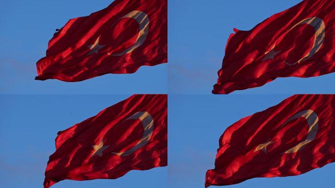 土耳其国旗在蔚蓝的天空下舞动，象征着坚韧和团结