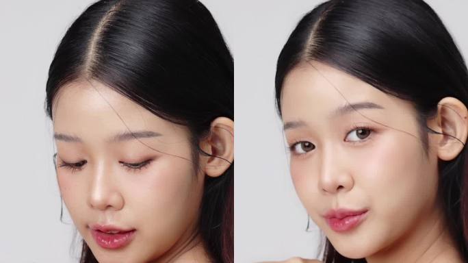 近距离的年轻美丽的年轻亚洲妇女的脸，健康和新鲜的皮肤。垂直美容镜头。