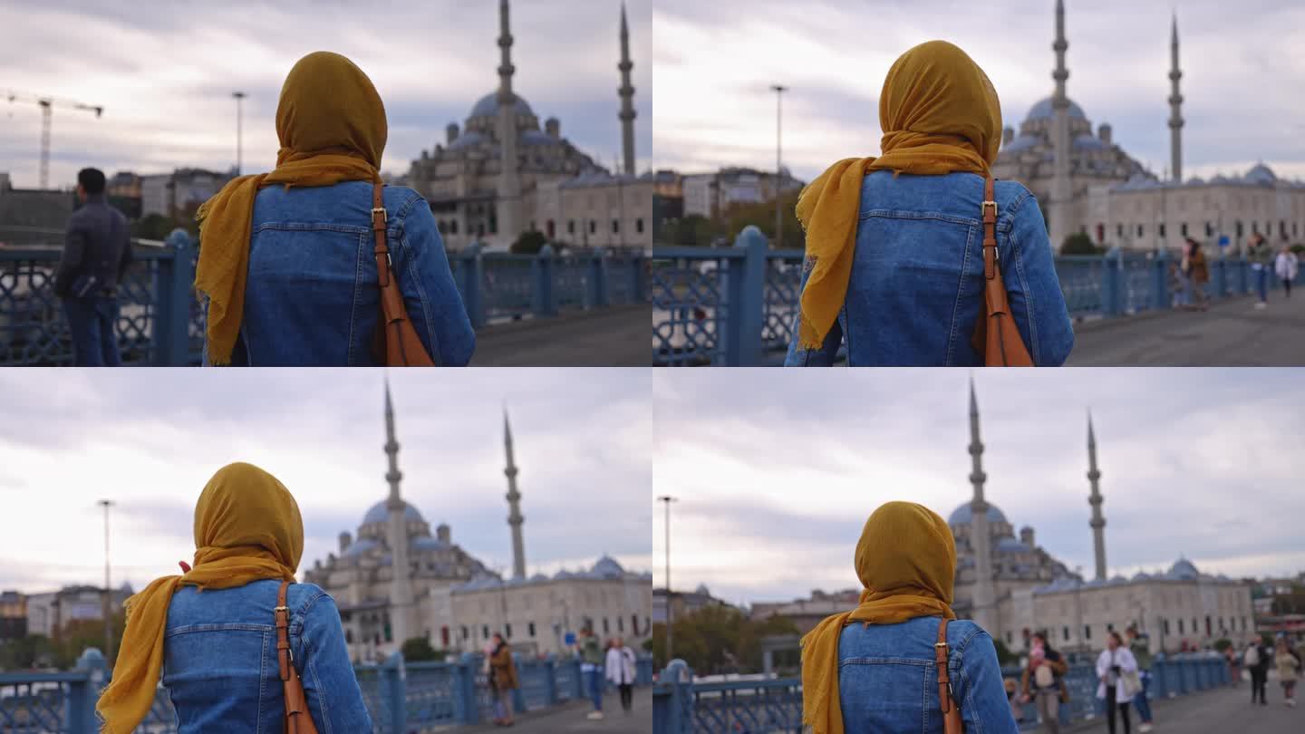 欣赏Yeni Cami清真寺景色的女游客